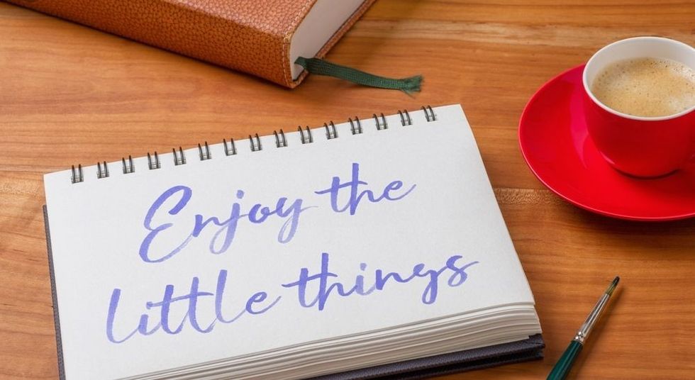 Notepad on a desk - Enjoy the little things.