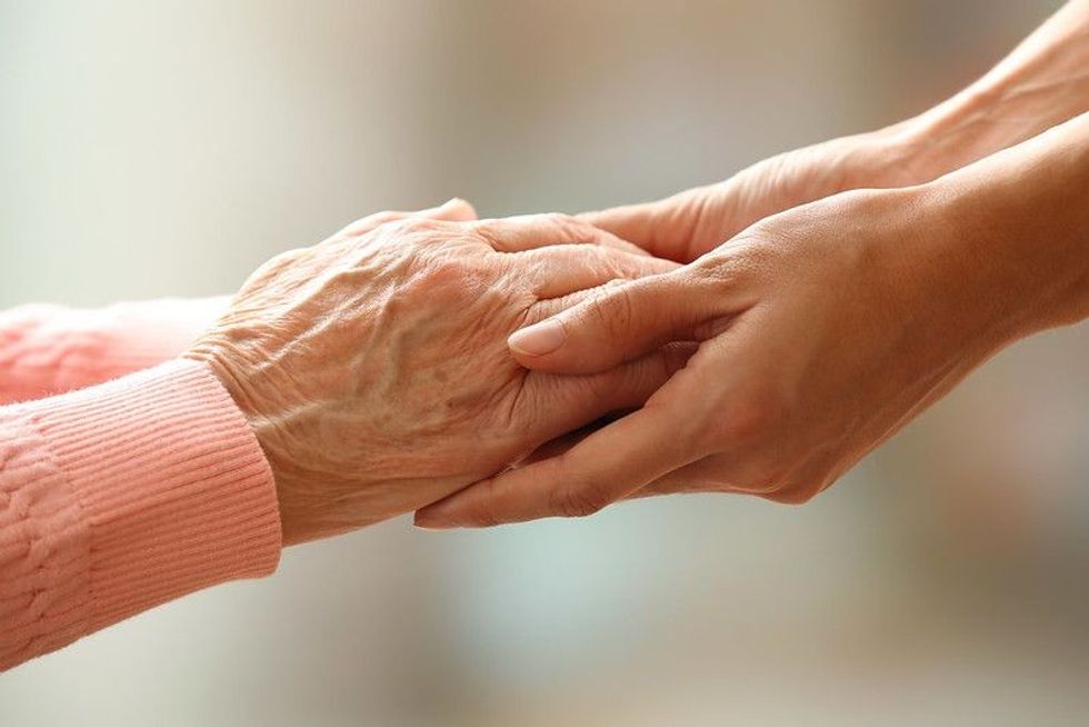 Old and young holding hands on.