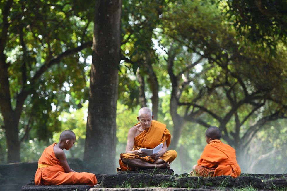 Old Monk are teaching little monks.