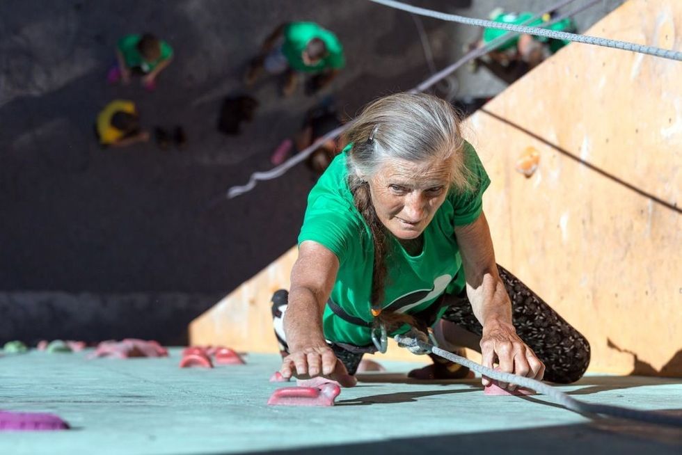 old women climbing the wall