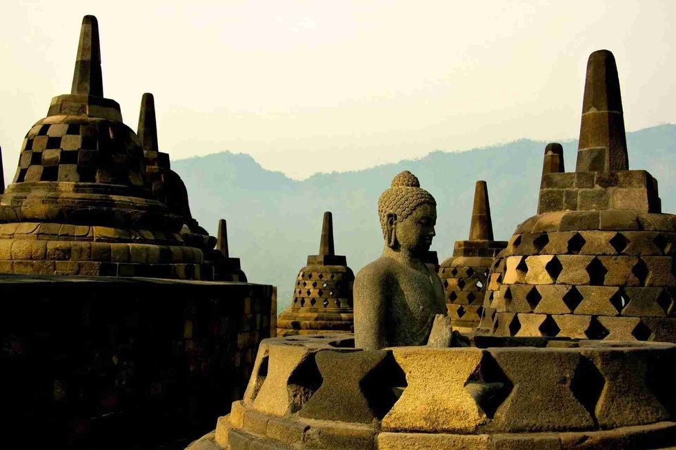 One of the Borobudur Temple facts is that 72 statues of Buddha surround the central dome of the temple.