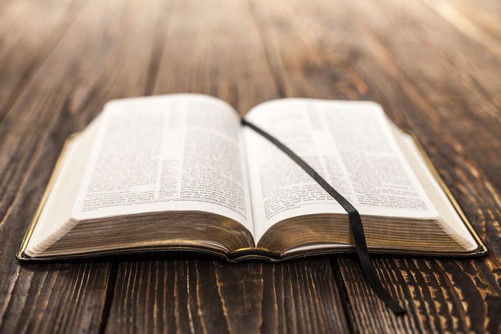 Open book on wood background.