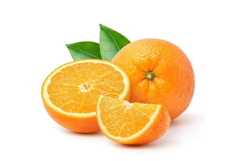 Orange with cut in half and green leaves isolated on white background.