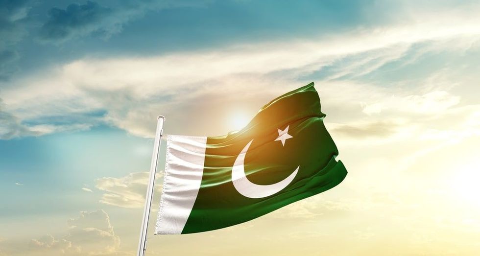 Pakistan national flag waving in beautiful clouds