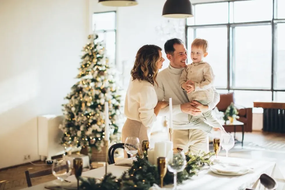 Parents with their son are enjoying Christmas in their home