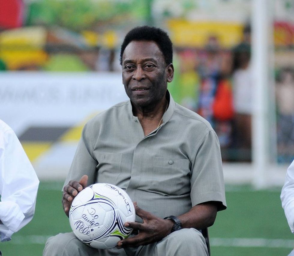 Pele sitting with a football