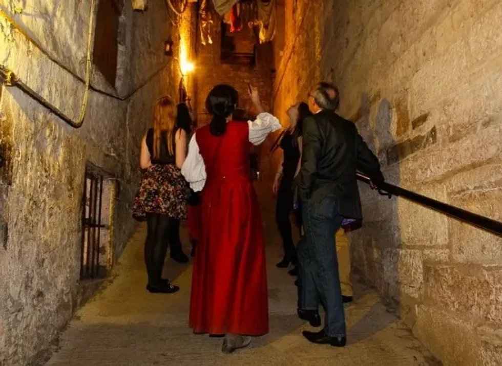 People walking through 17th century streets at The Real Mary King's Close.