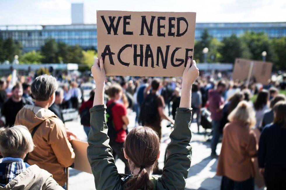 people with placards and posters on global strike for climate change