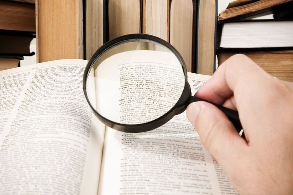 Person finding a word in dictionary