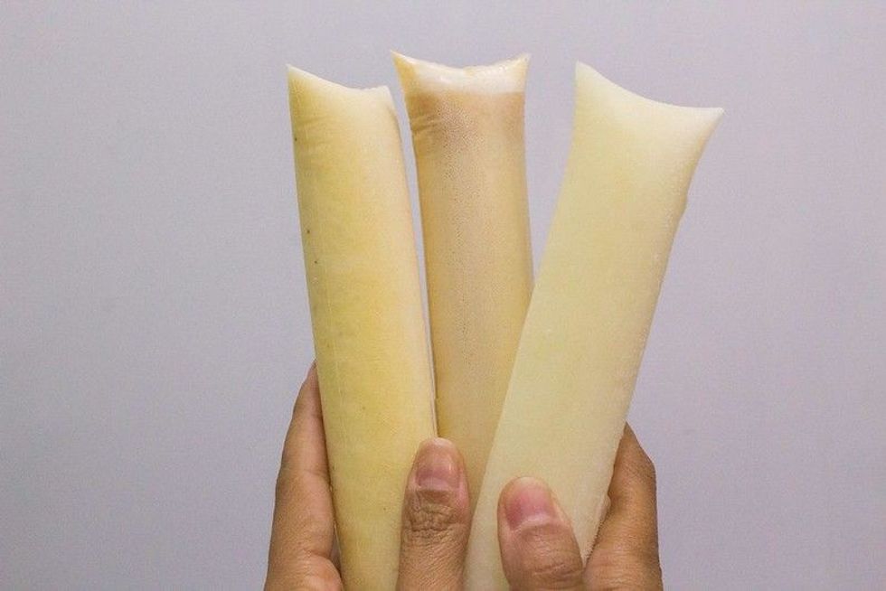 Person holding three Freezer pops