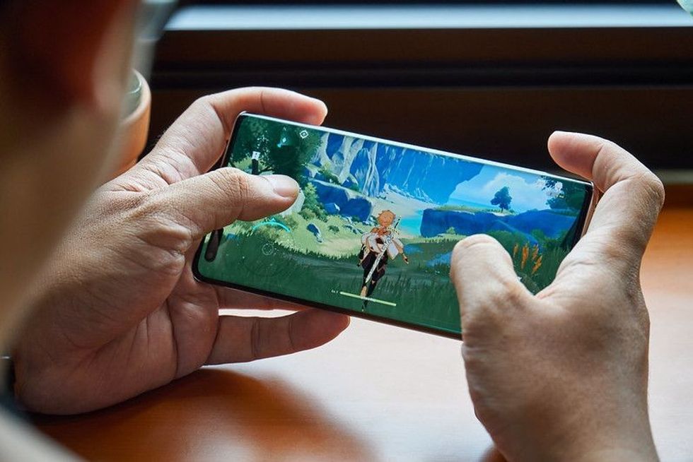 Person playing game in mobile phone
