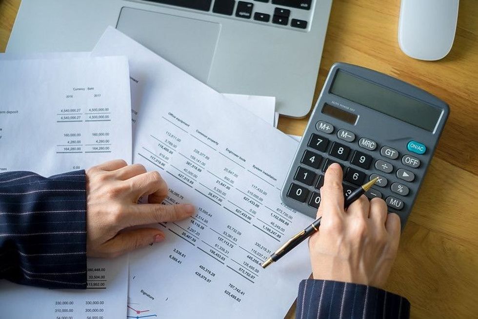 Person using calculator for doing accounts