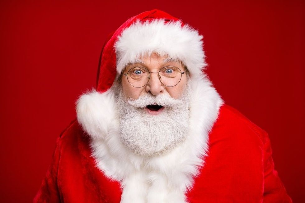 Photo of an old man grey beard wearing santa costume coat and spectacles