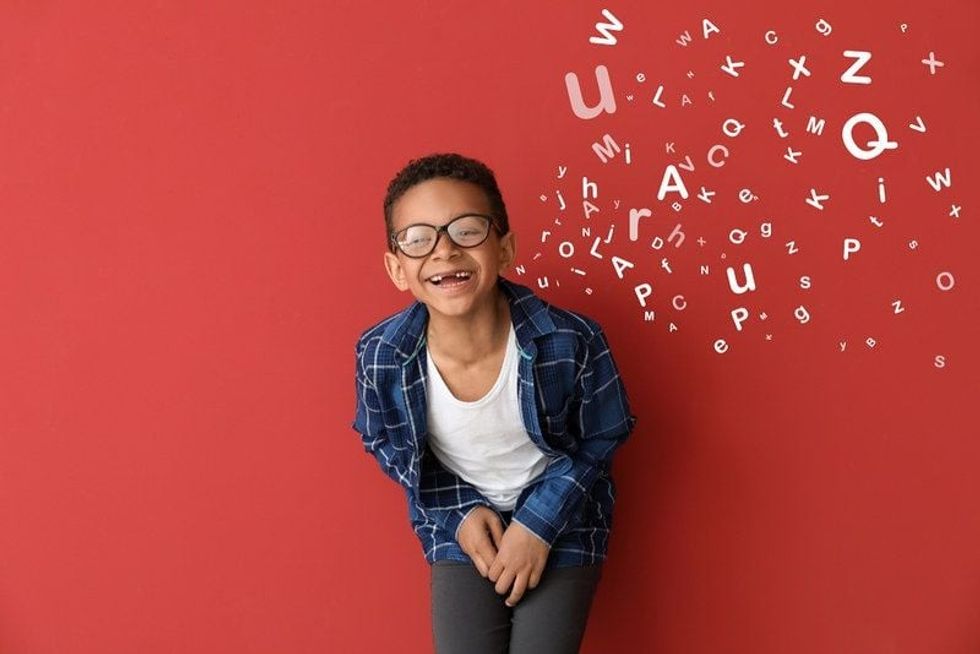 picture of a boy with glasses laughing hard
