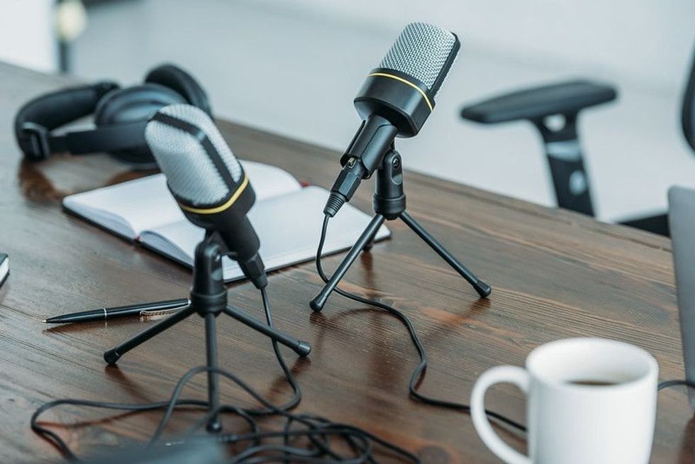 Podcast setup on wooden table.
