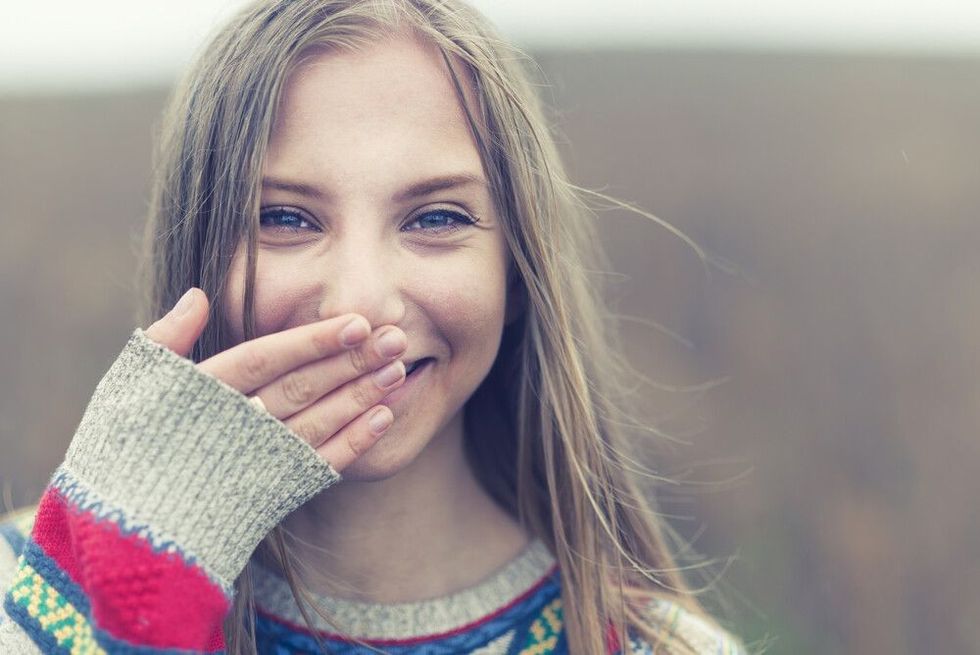 Portrait of a beautiful happy smiling girl outdoors in spring