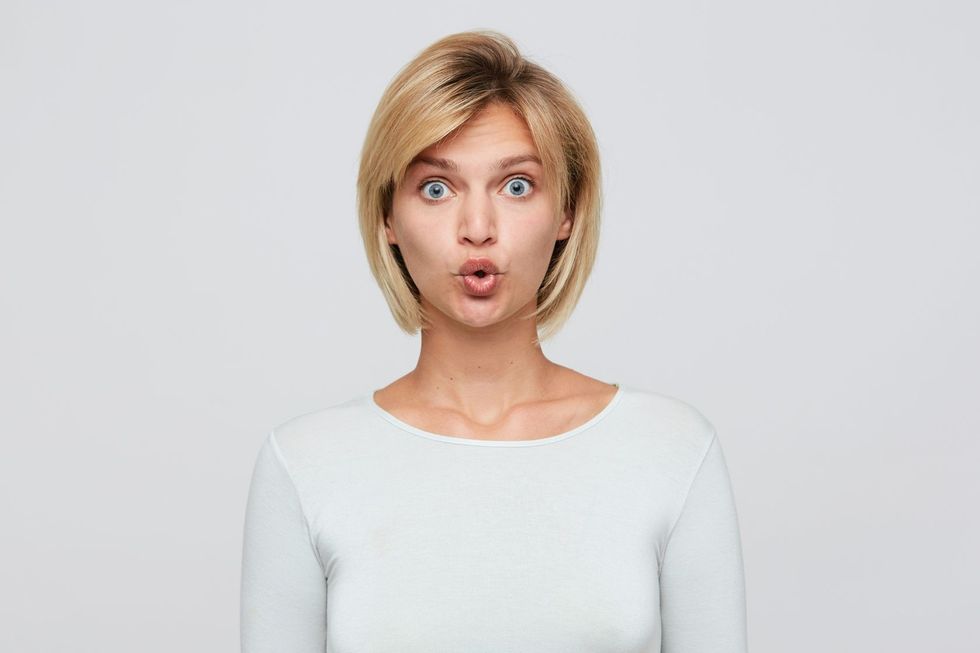 Portrait of a blonde woman with wide open blue eyes.