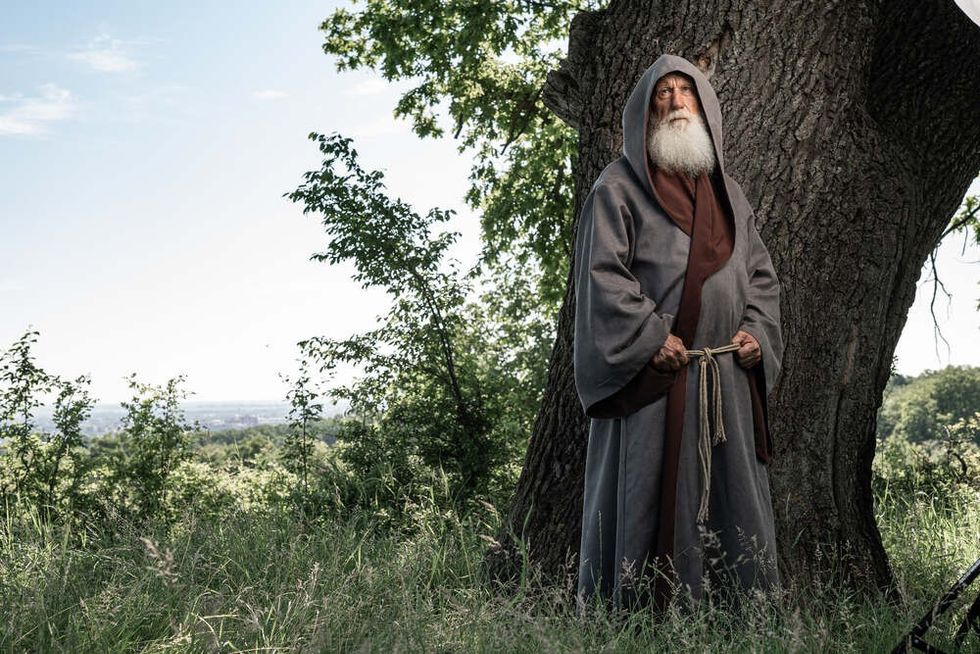 Portrait of a Monk in a black cassock in the forest, a wandering druid in an cassock