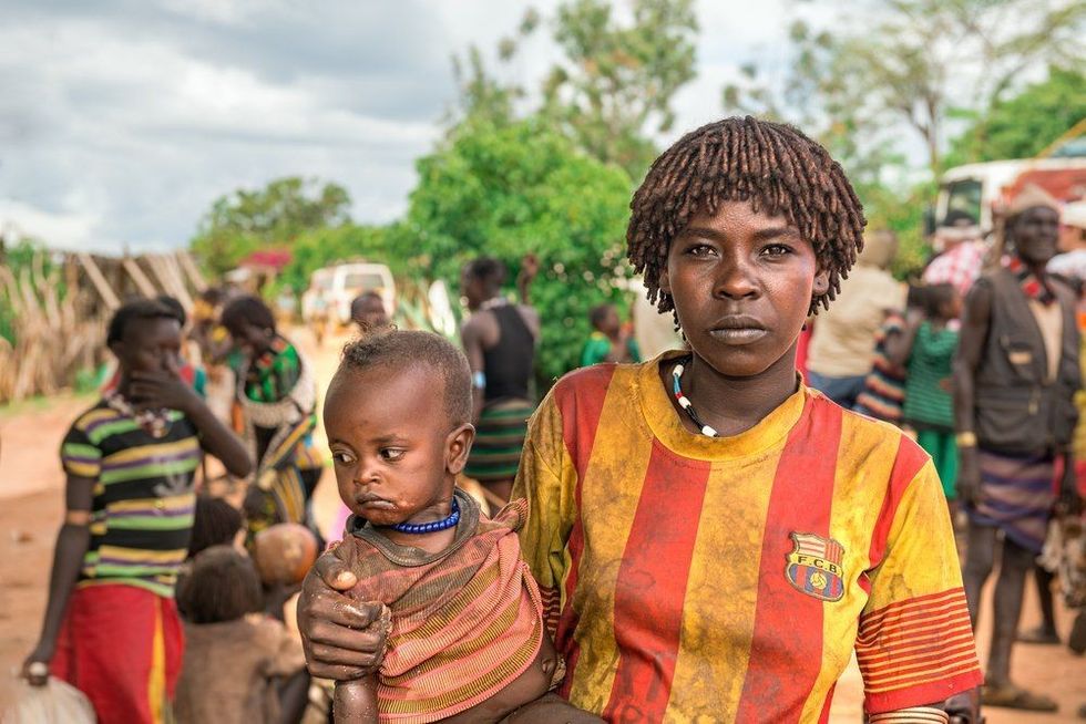 Portrait of a woman from the Hamar tribe with her baby in south Ethiopia.