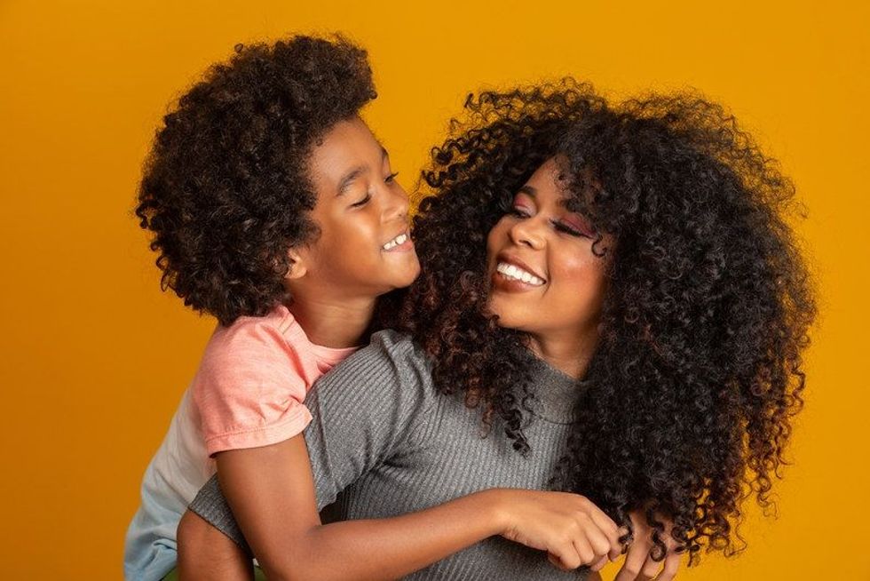 Portrait of Mother and her son having natural curly hair