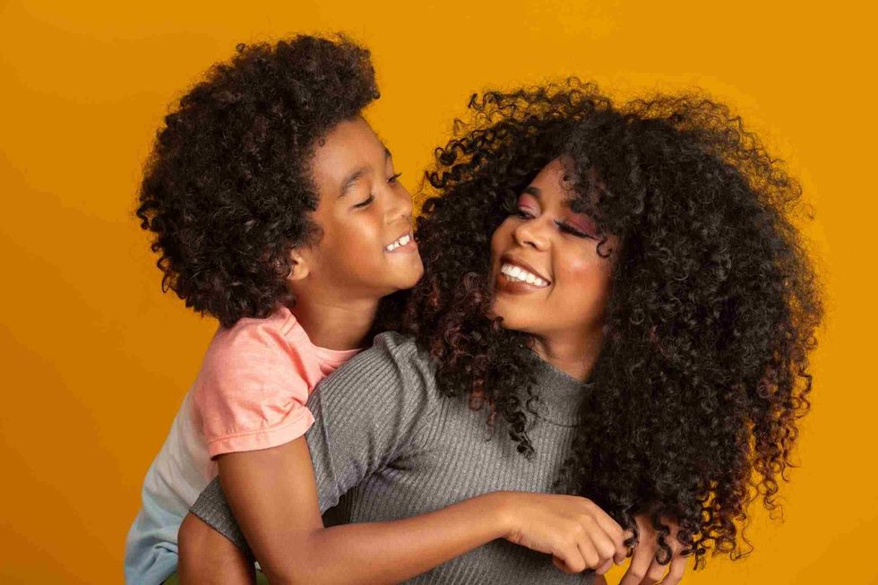 Portrait of Mother and her son having natural curly hair 