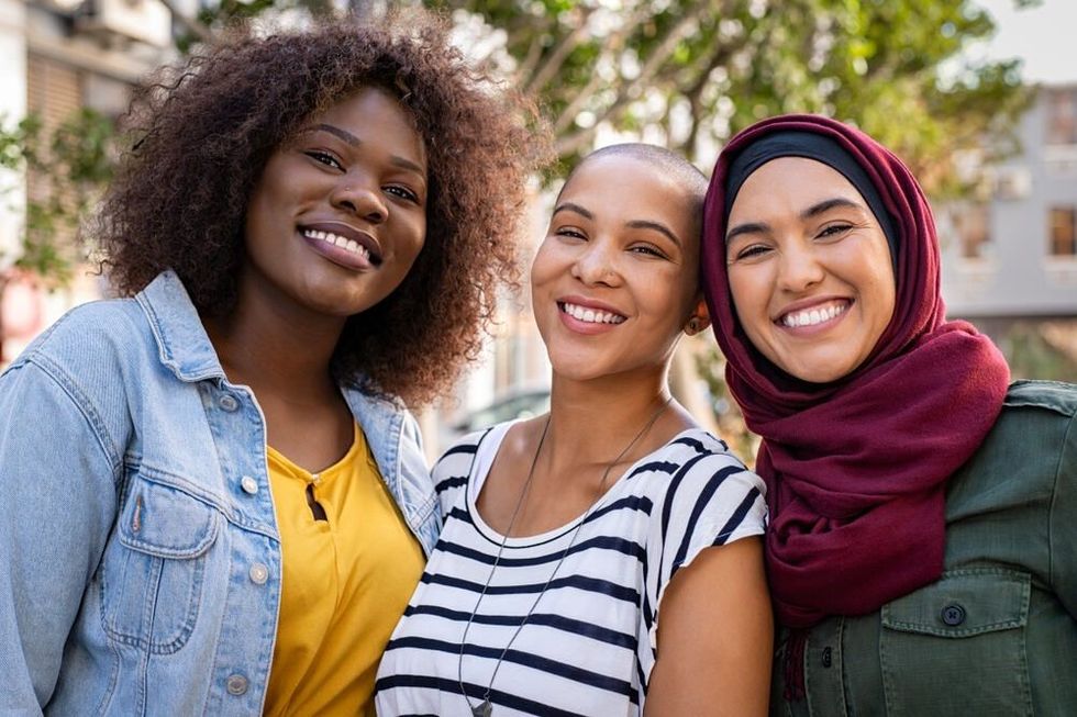  Portrait of young women of different cultures enjoying vacation together. 