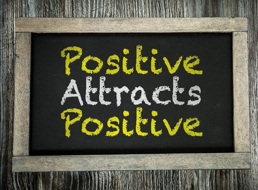 Positive Attracts Positive written on chalkboard.
