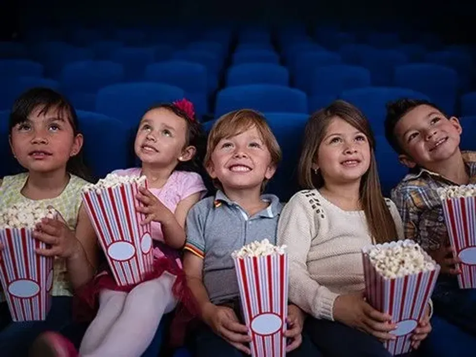 Preschoolers watching a movie at the cinema.
