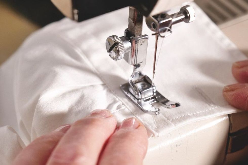 Professional sewing machine stitching with white thread