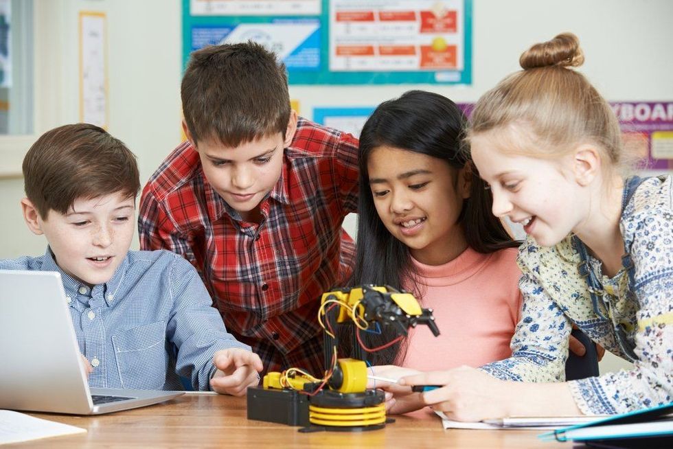 Pupils in science lesson studying robotics