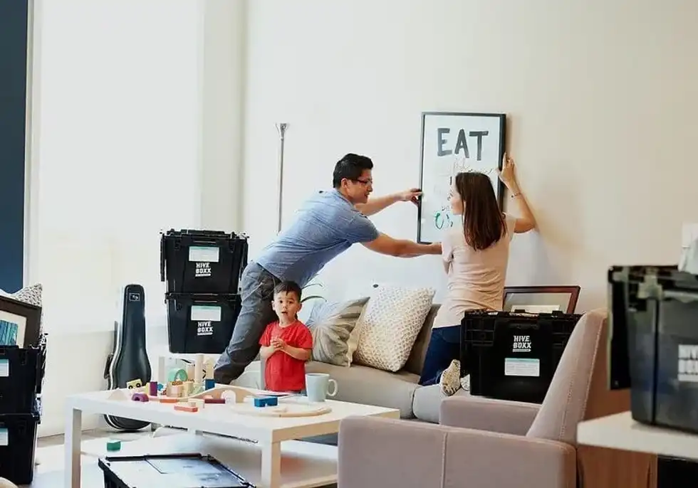 Putting some artwork on the wall.