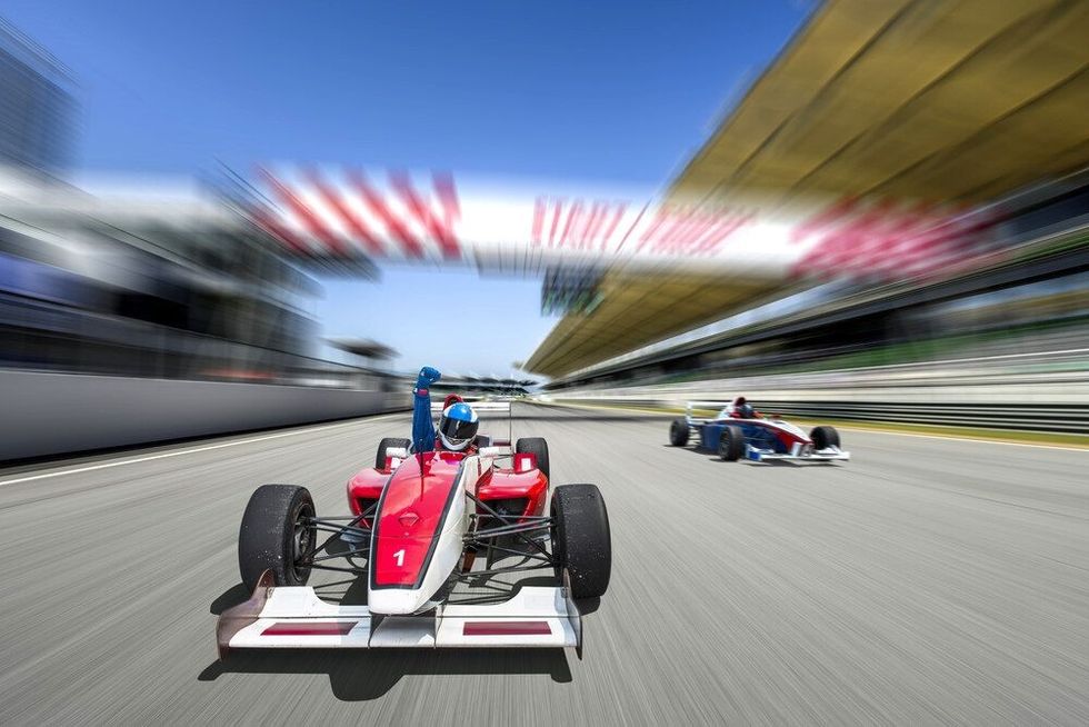 Race car racing on a track with motion blur.