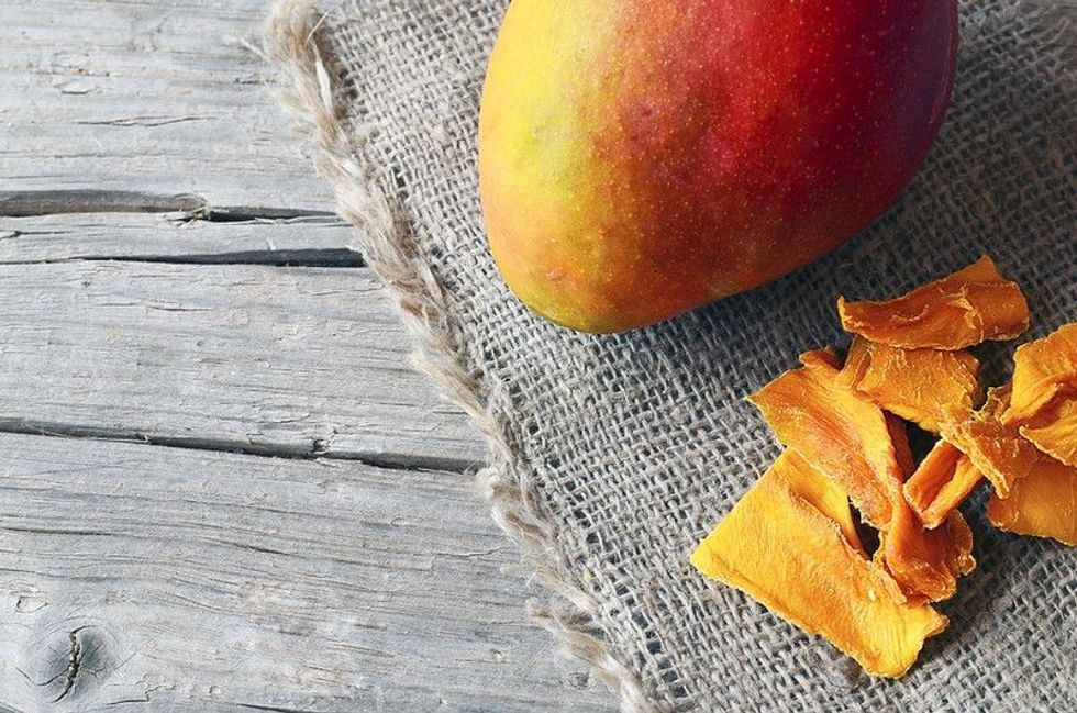 Raw organic dried mango and fresh ripe mango fruit