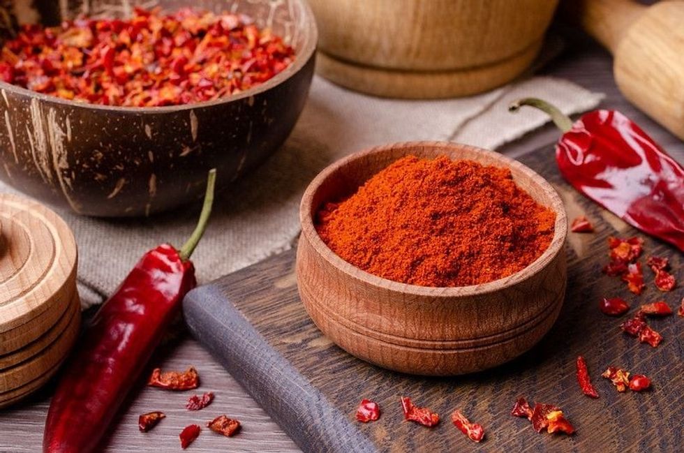 Red dried pepper on a dark wooden background.