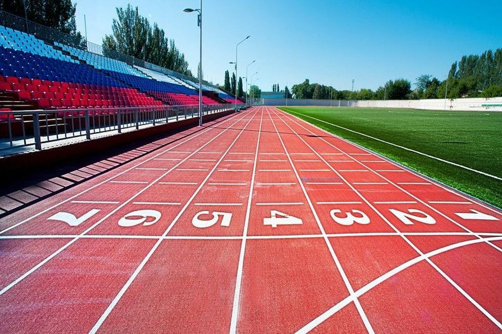 Red treadmill at the stadium with the numbering from one to seven.