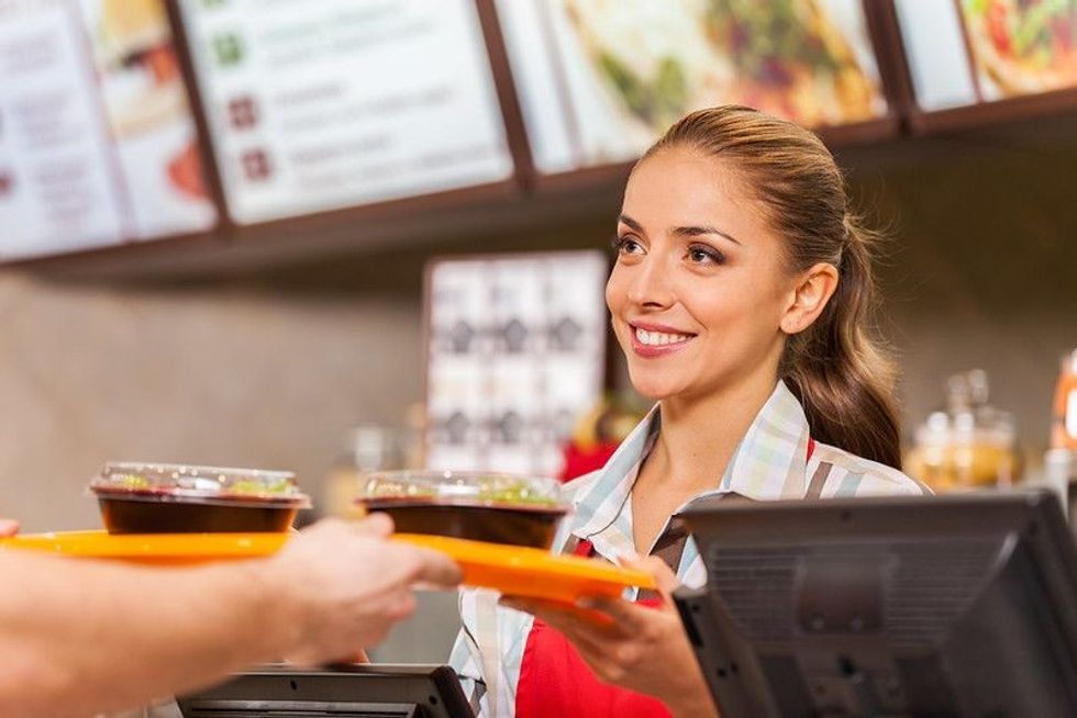 Restaurant worker holding tray