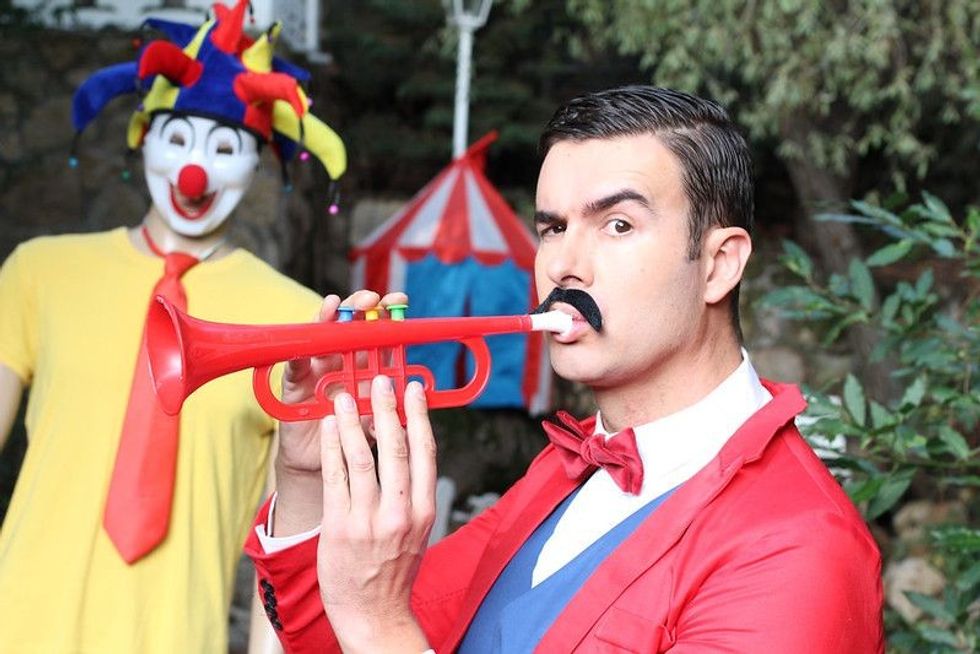 Ringmaster playing the trumpet in the circus