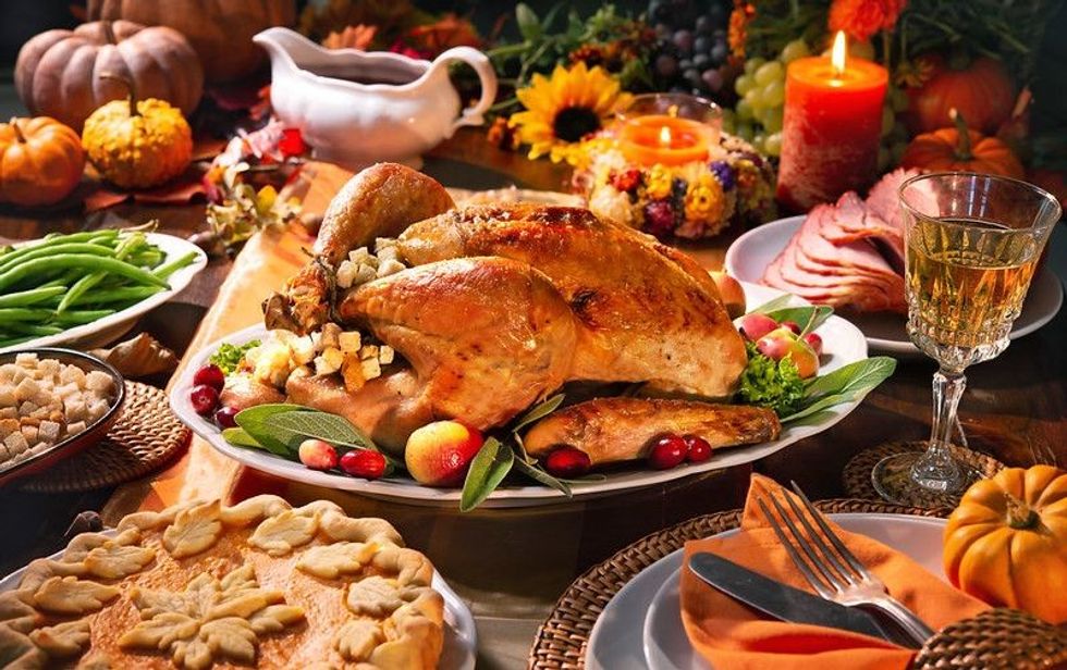 Roasted turkey garnished with cranberries.