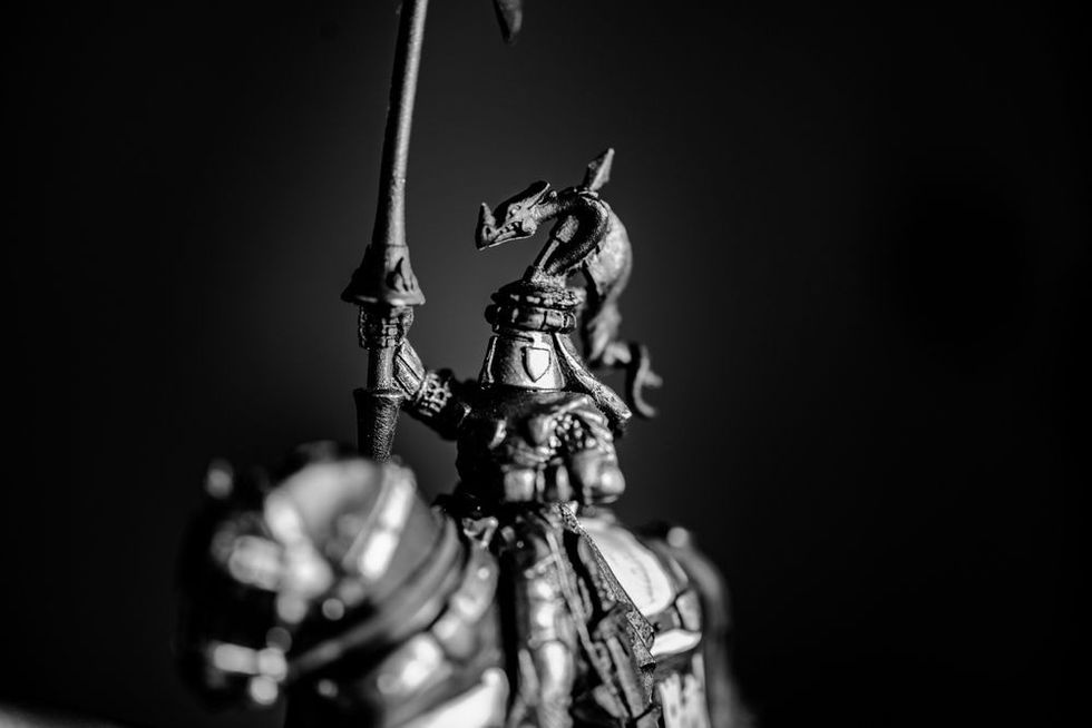 Role playing game miniature of table top game hammer of war and strategy game of a midevil knight on horse and mediaval warrior.
