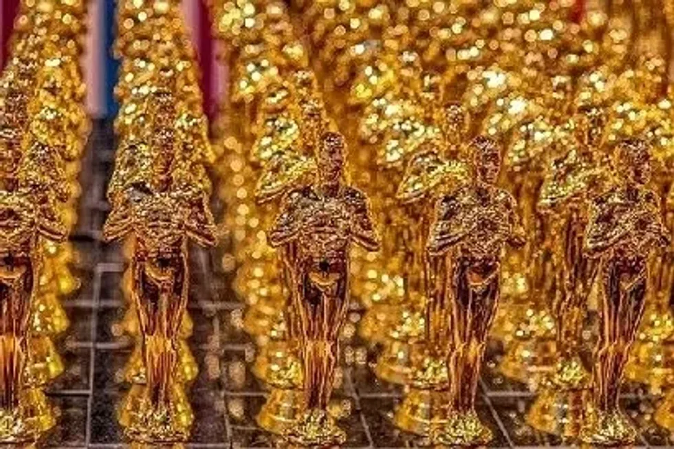 Rows of Oscar awards forming a glittering backdrop, perfect for learning Academy Award Facts.