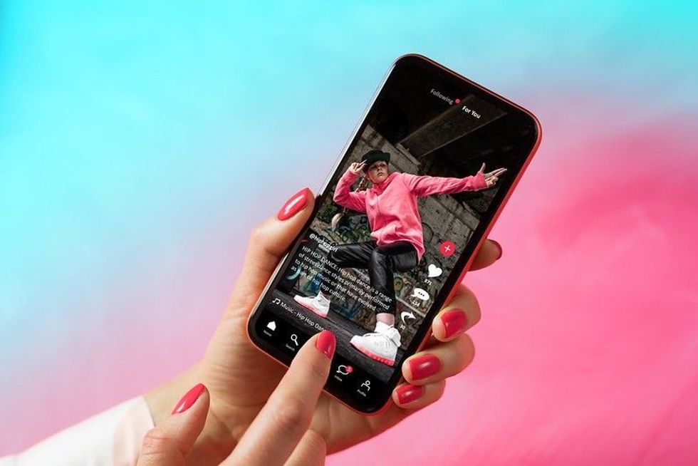 Sample social media app interface on mobile phone showing shared video content.