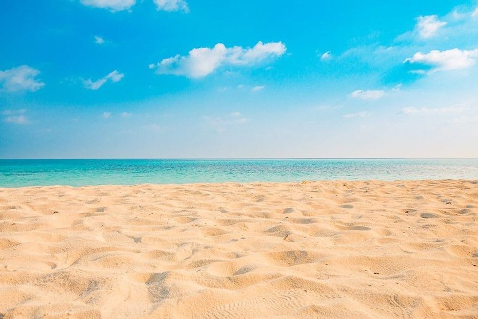 Sand on beach and blue summer sky.