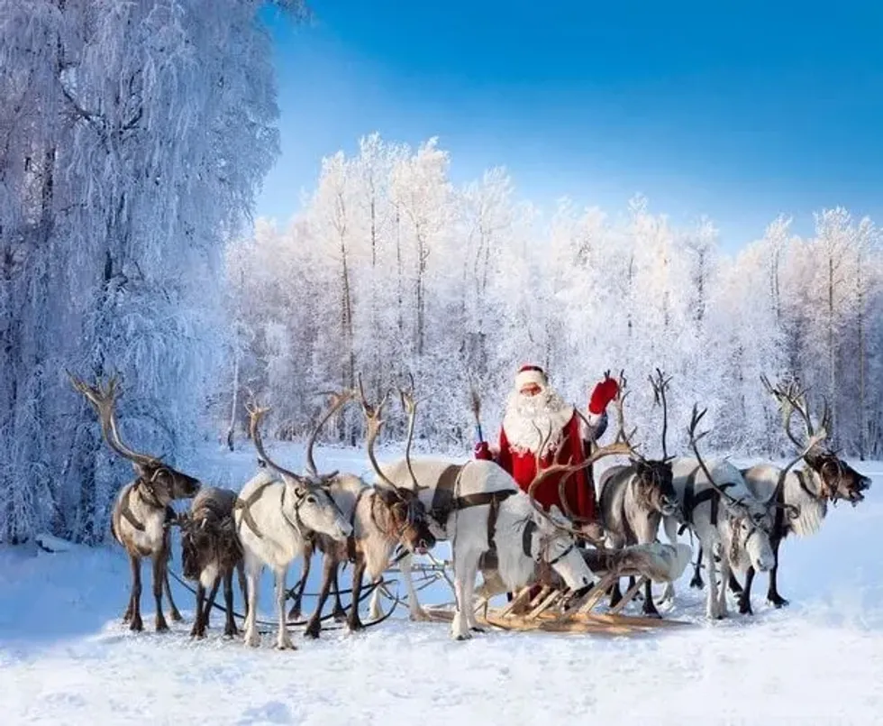 Santa and his reindeers in white snow