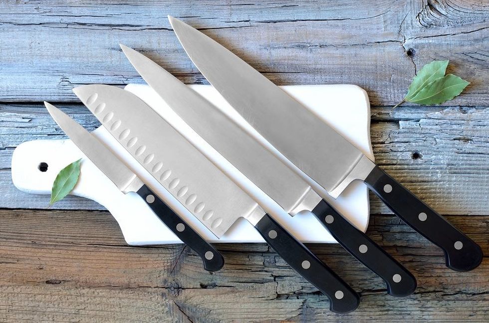 Set of kitchen knives on a board.