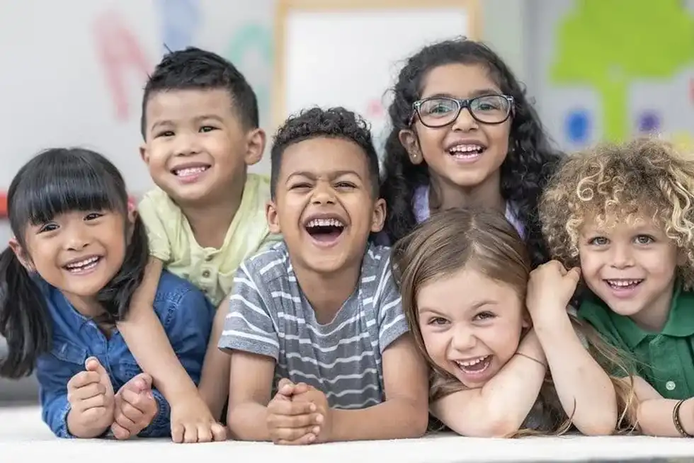 Six kids in fits of giggles, laughing at skeleton jokes.