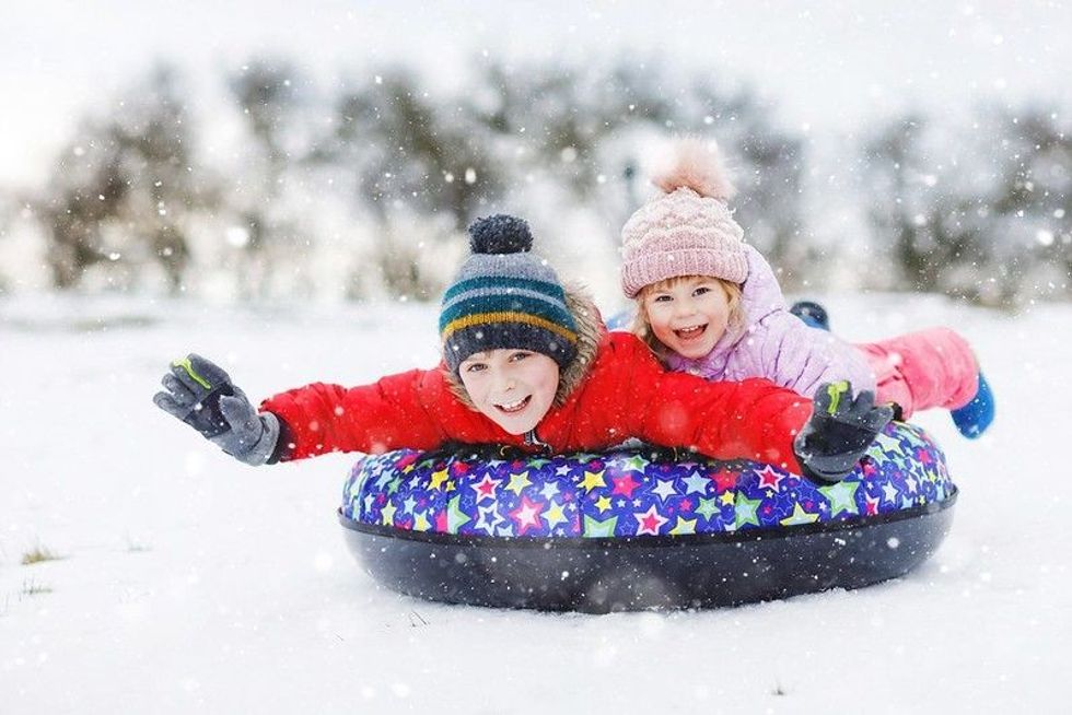 Sliding down the hill on snow tube