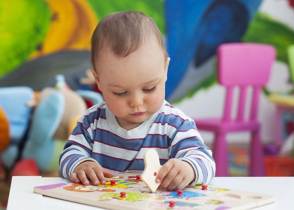 Small baby boy playing and learning