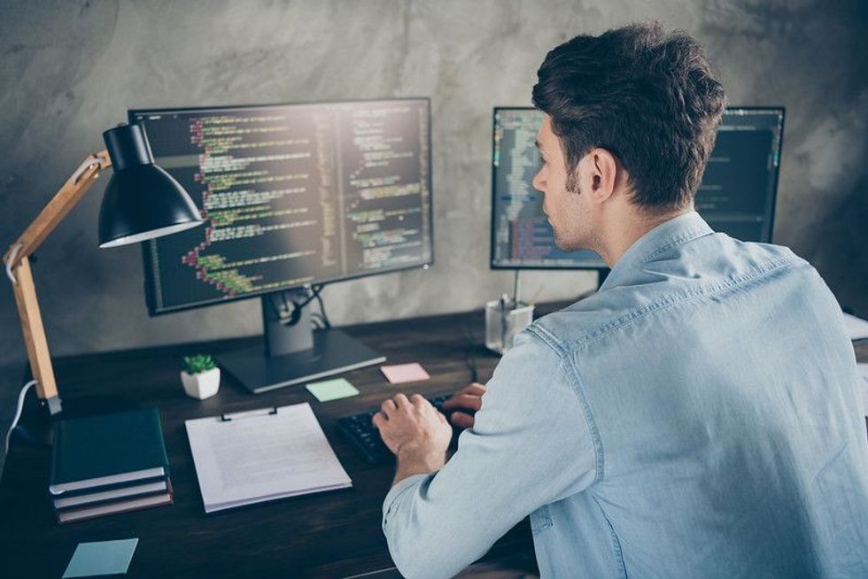 Software engineer coding on computer