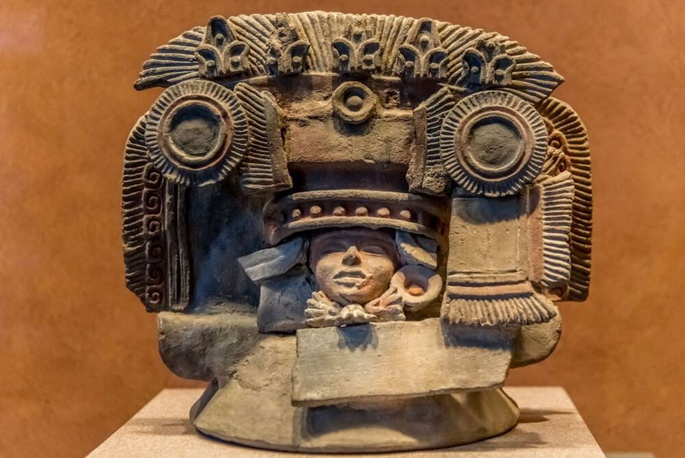 Statue of Aztec god carved in stone.
