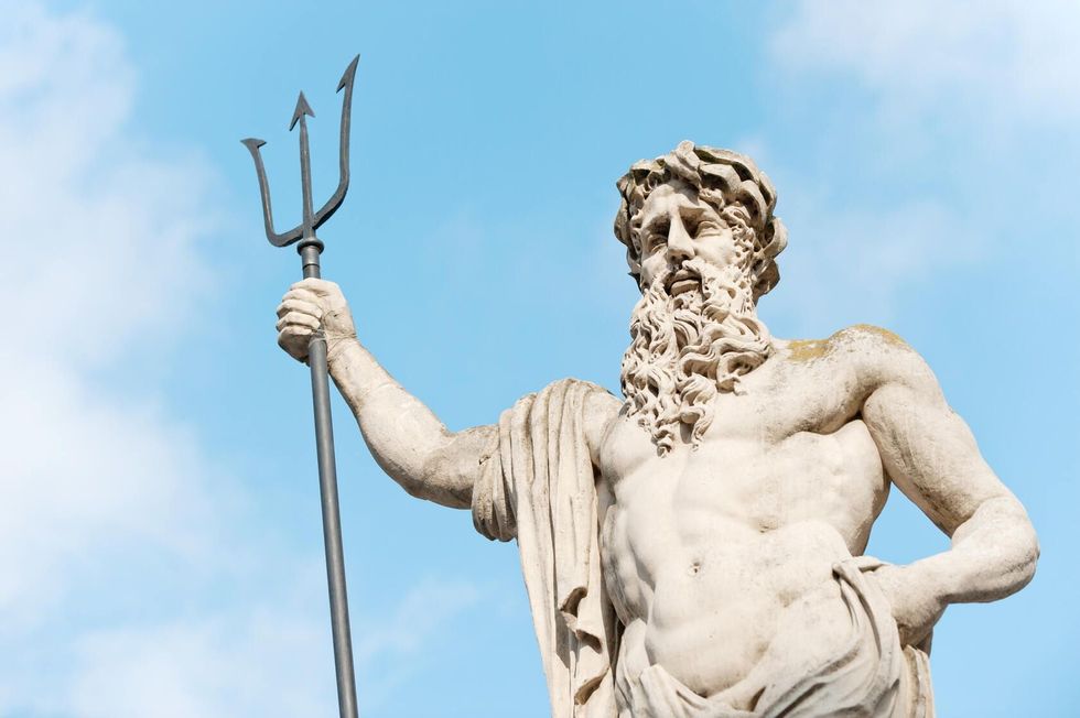 Statue of Neptune with his weapon.